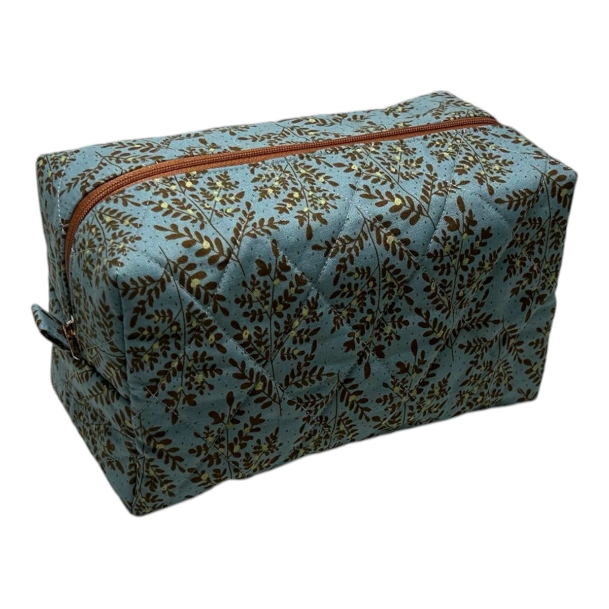 Ferns & Fronds toiletry bag — quilted blue fabric with brown fern print and copper zipper